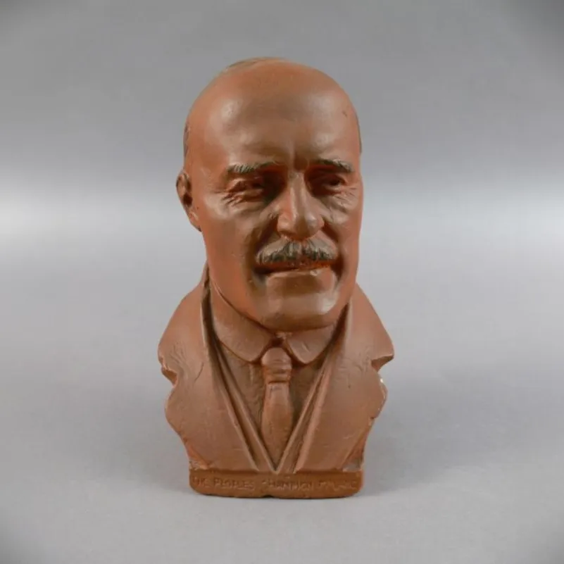 A terracotta clay bust of Jack Lang, wearing a tie and jacket lapels.