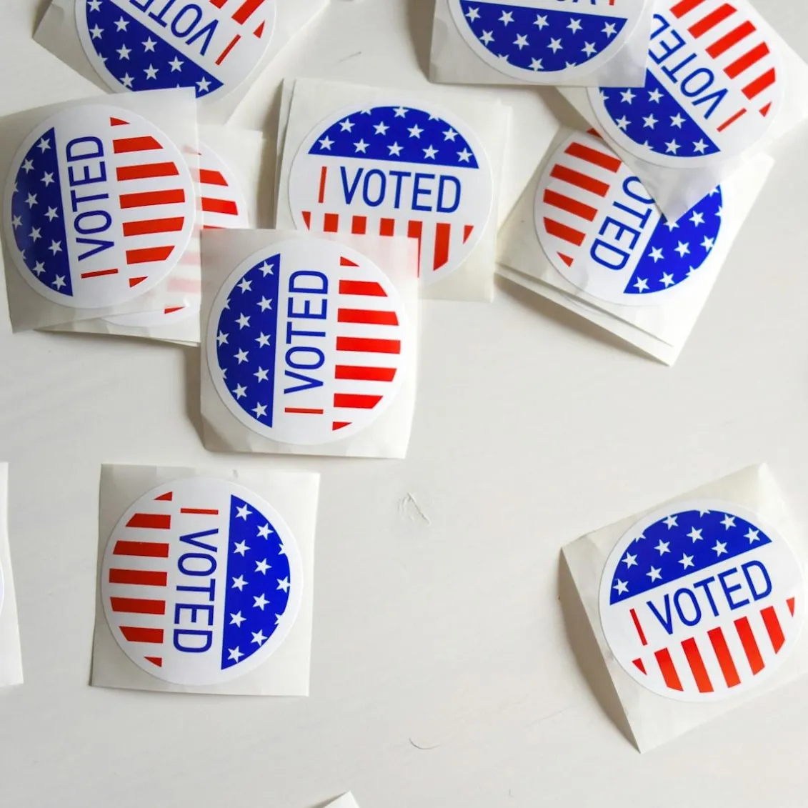 Round stickers depicting the US flag's stars and stripes, with the words 'I voted'.