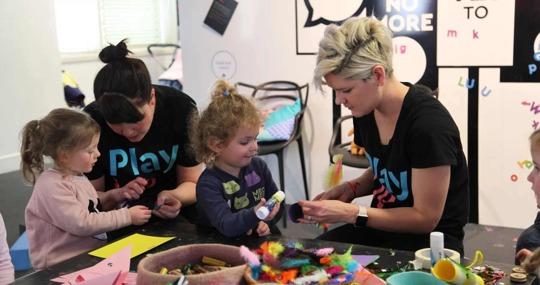 Two children playing with two PlayUP staff members Two children playing with two PlayUP staff members