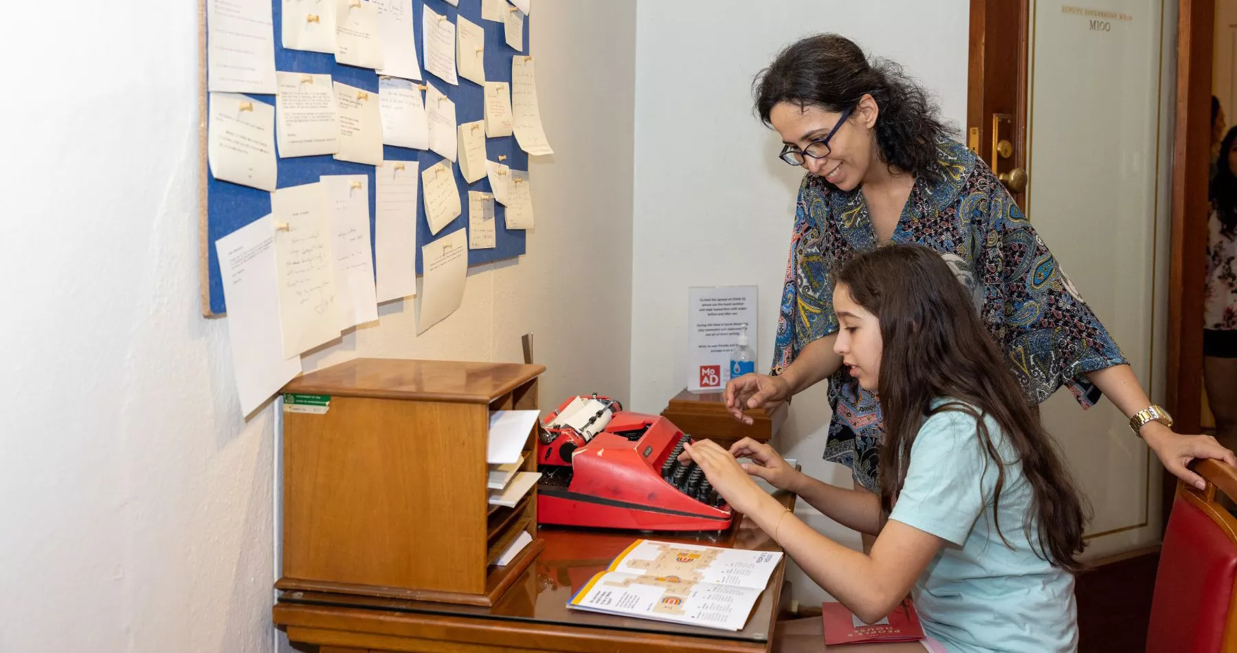 One visitor sat trying out a red typewriter while another watches