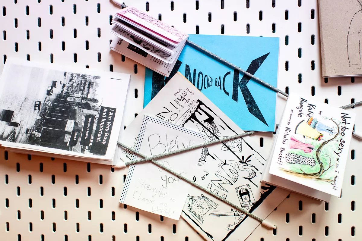 A pinboard with handmade zines pinned to it. 