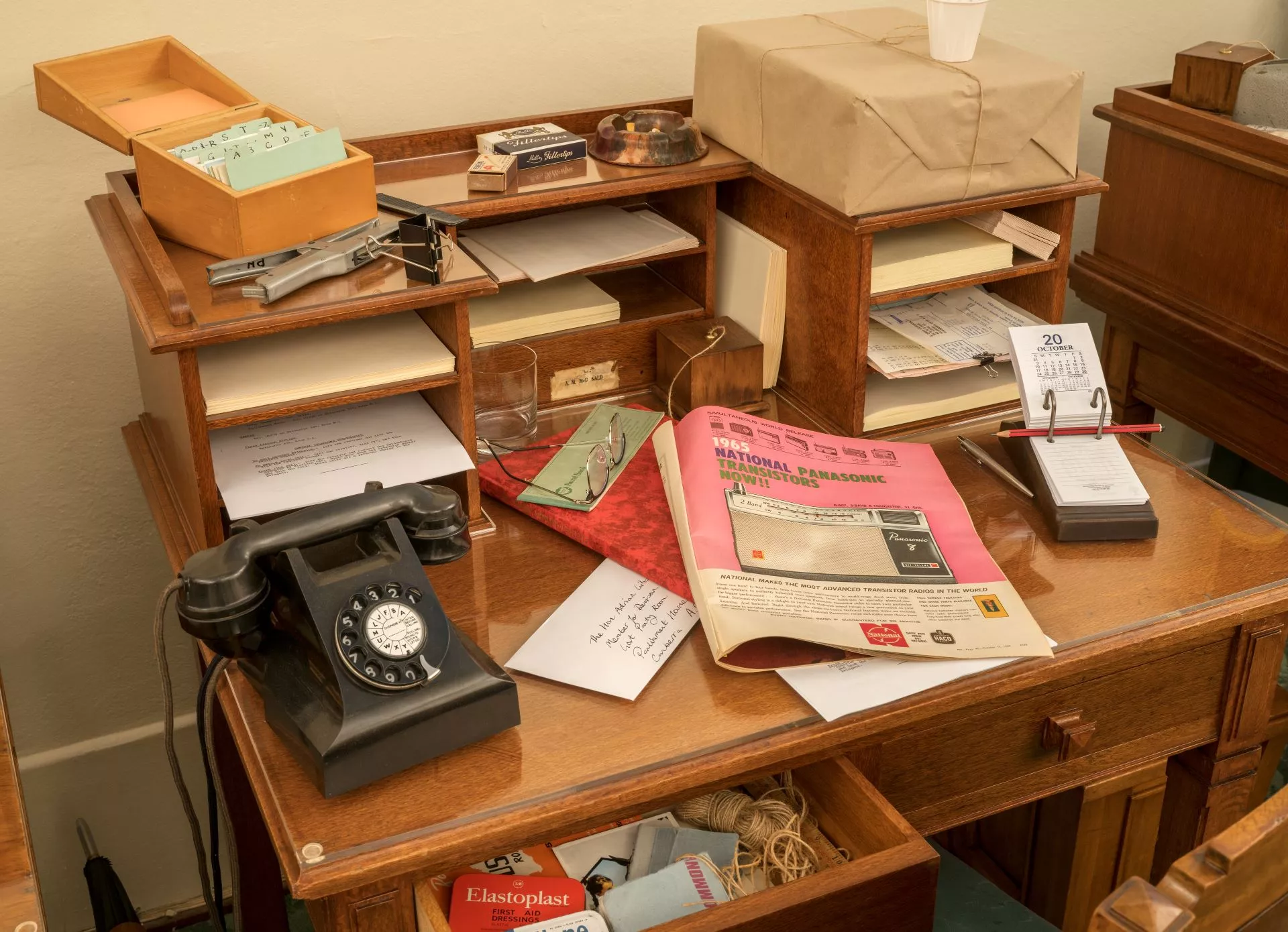 Photograph of a table covered in an assortment of prop historical objects in the Government Party Room