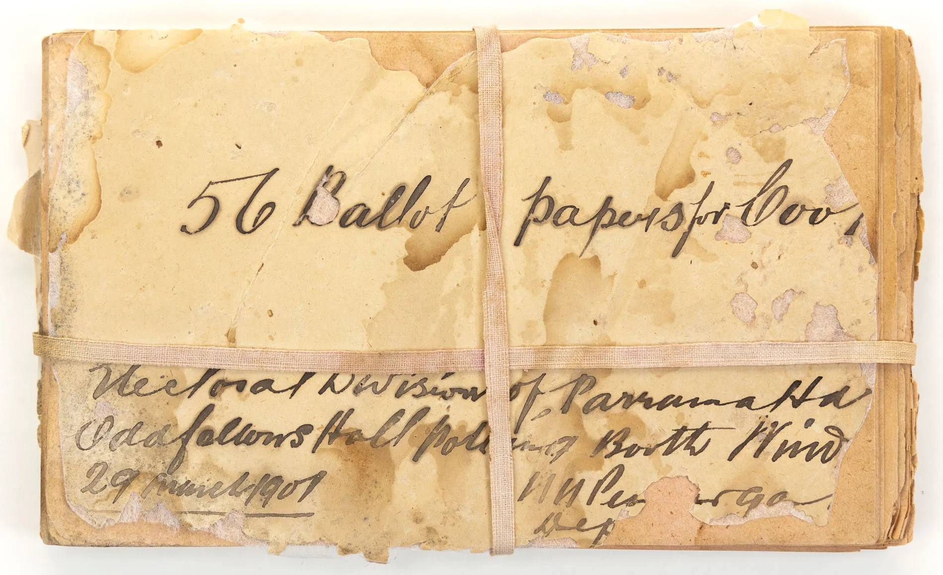 Aged yellow papers with calligraphy text including '56 Ballot papers' and '29 March 1901' are tied together with aged hessian ribbon.