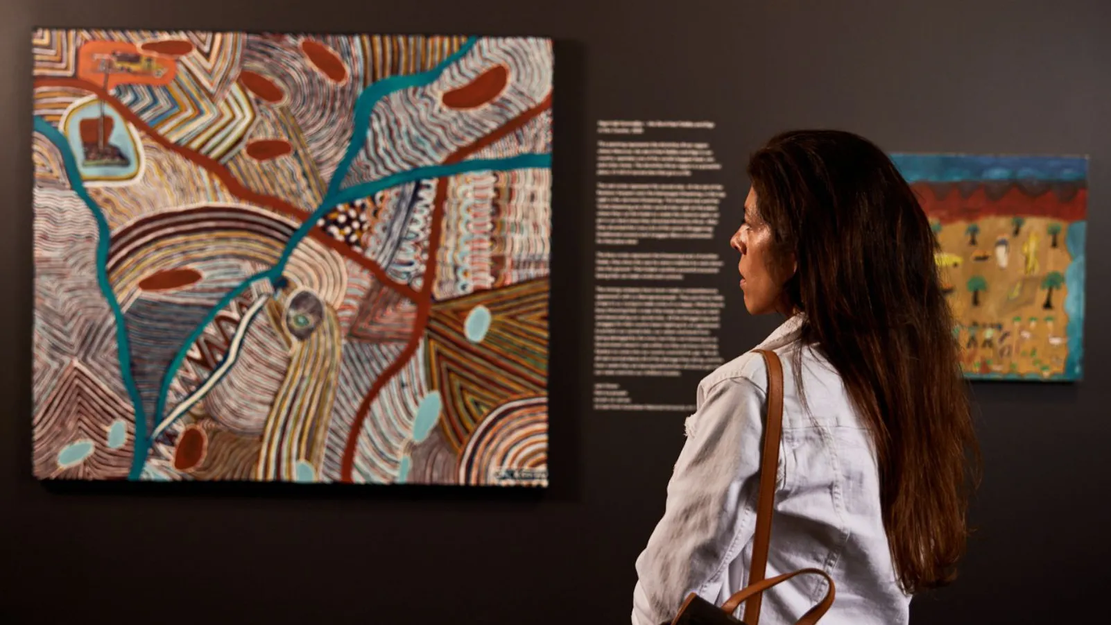 A woman looking at one of the features A woman looking at one of the features