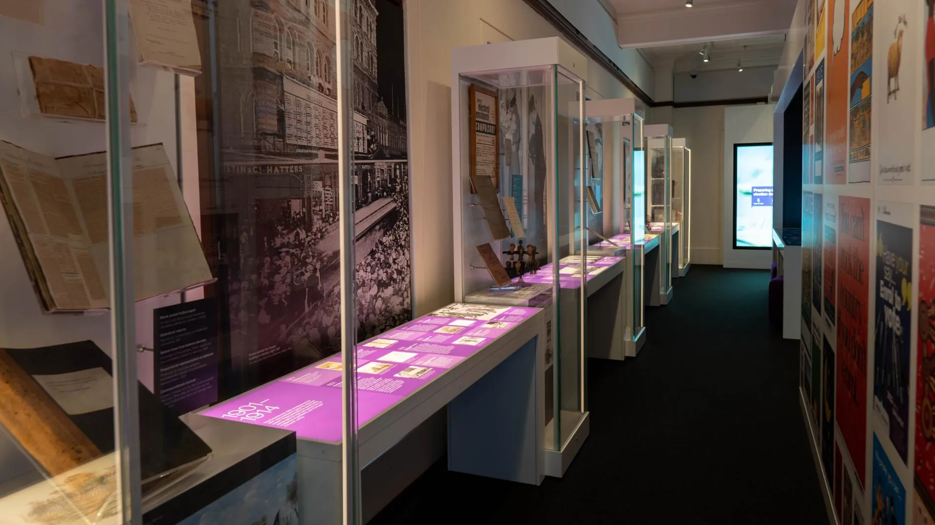 An exhibition space with glass showcases filled with objects An exhibition space with glass showcases filled with objects