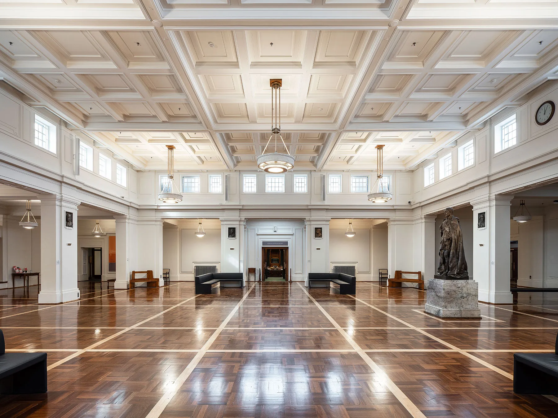 King's Hall at MoAD at Old Parliament House featuring parquetry floors, a statue, couches and hanging lights from an ornate ceiling. King's Hall at MoAD at Old Parliament House featuring parquetry floors, a statue, couches and hanging lights from an ornate ceiling.