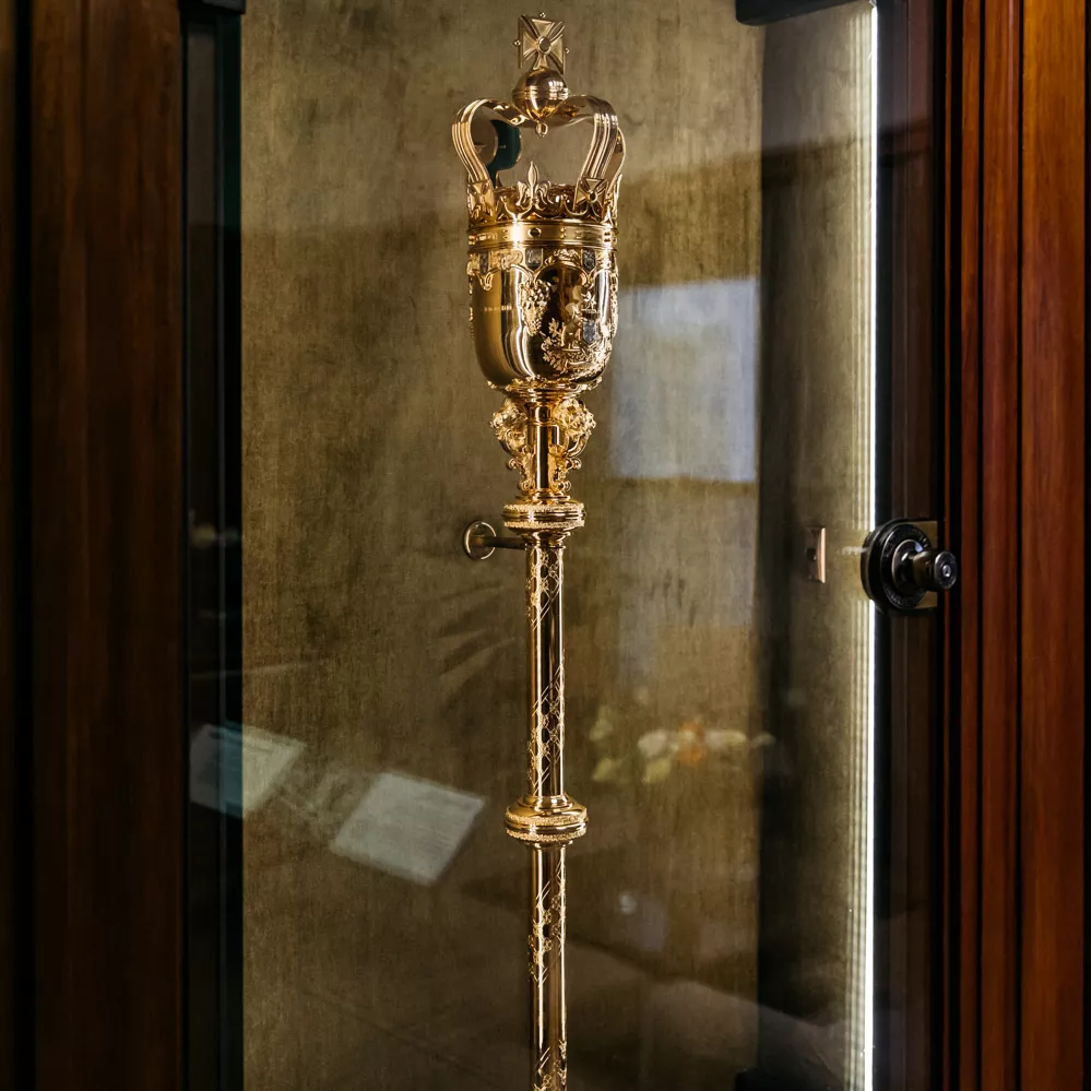 See a replica of the mace that was securely housed in the Speaker's office (the real one is at Australian Parliament House). Parliamentary proceedings can’t start until the Speaker is in the Chamber and the mace is placed in its cradles on the central table. A replica of the mace that was securely housed in Joan’s office