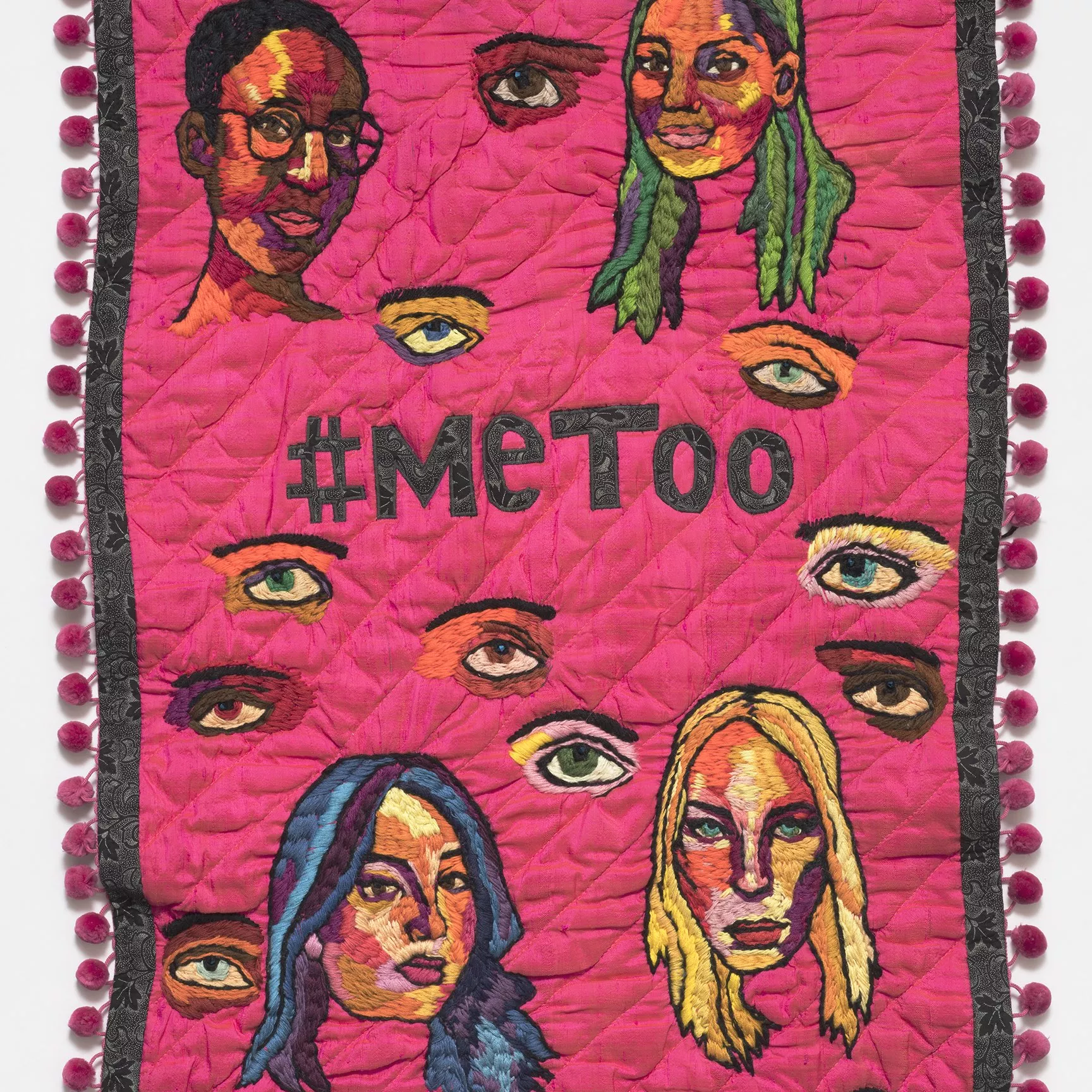 #metoo by Sofia Fitzpatrick and Tal Fitzpatrick. A pink embroidered banner with the words #metoo in the centre and images of women's face surrounding it.