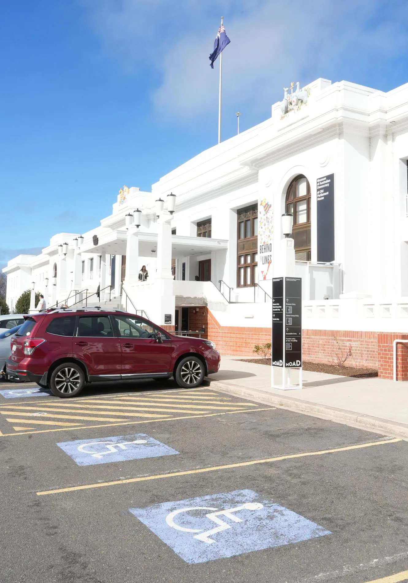 Accessible parking and cars in parking bays outside MoAD at Old Parliament House. Accessible parking and cars in parking bays outside MoAD at Old Parliament House.