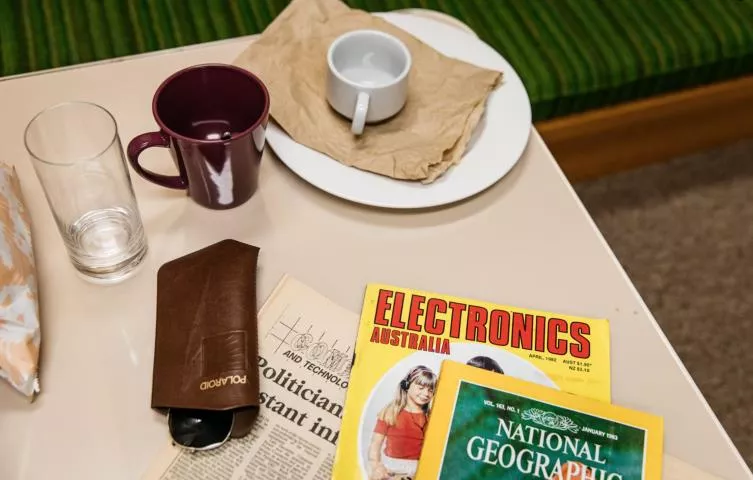 Cups and magazines on a table in the studio Cups and magazines on a table in the studio