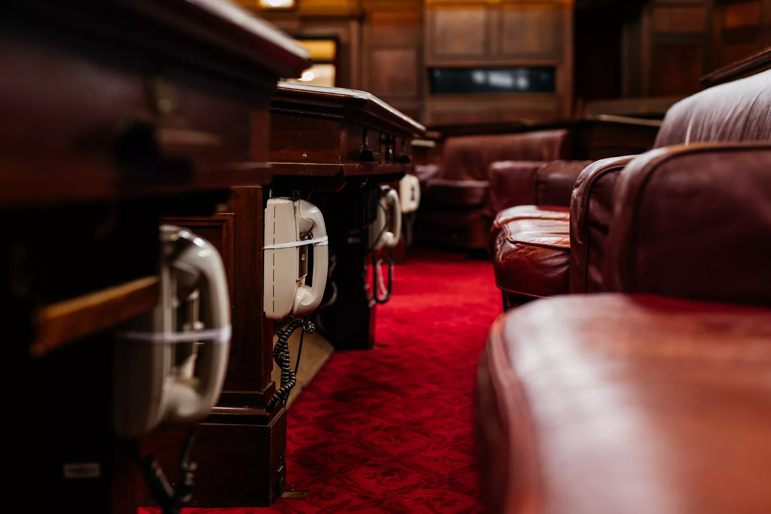 A close up of old fashioned phones underneath desks in the Senate Chamber. A close up of old fashioned phones underneath desks in the Senate Chamber.
